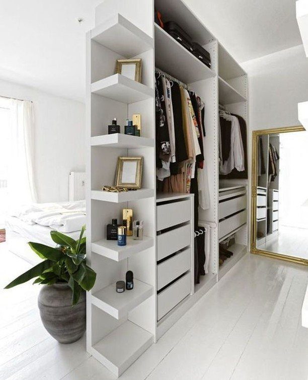 White open closet system with shelves and drawers in a bright bedroom