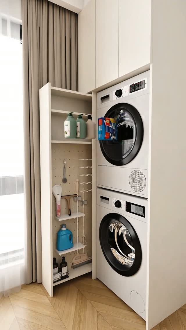 Stacked washer and dryer with white overhead cabinets and adjacent open storage shelving.