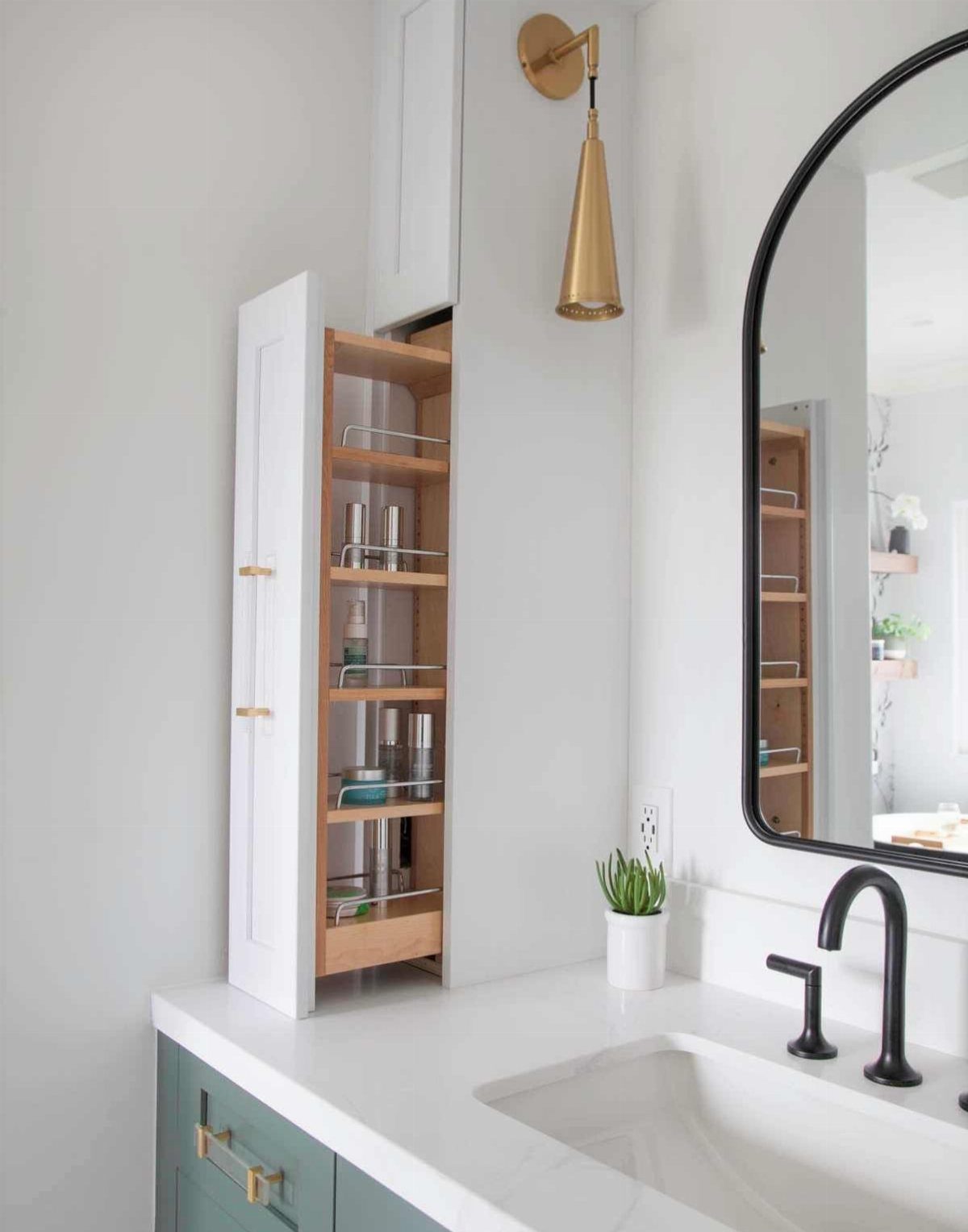 Pull-out wooden storage drawer with toiletries next to a white bathroom sink