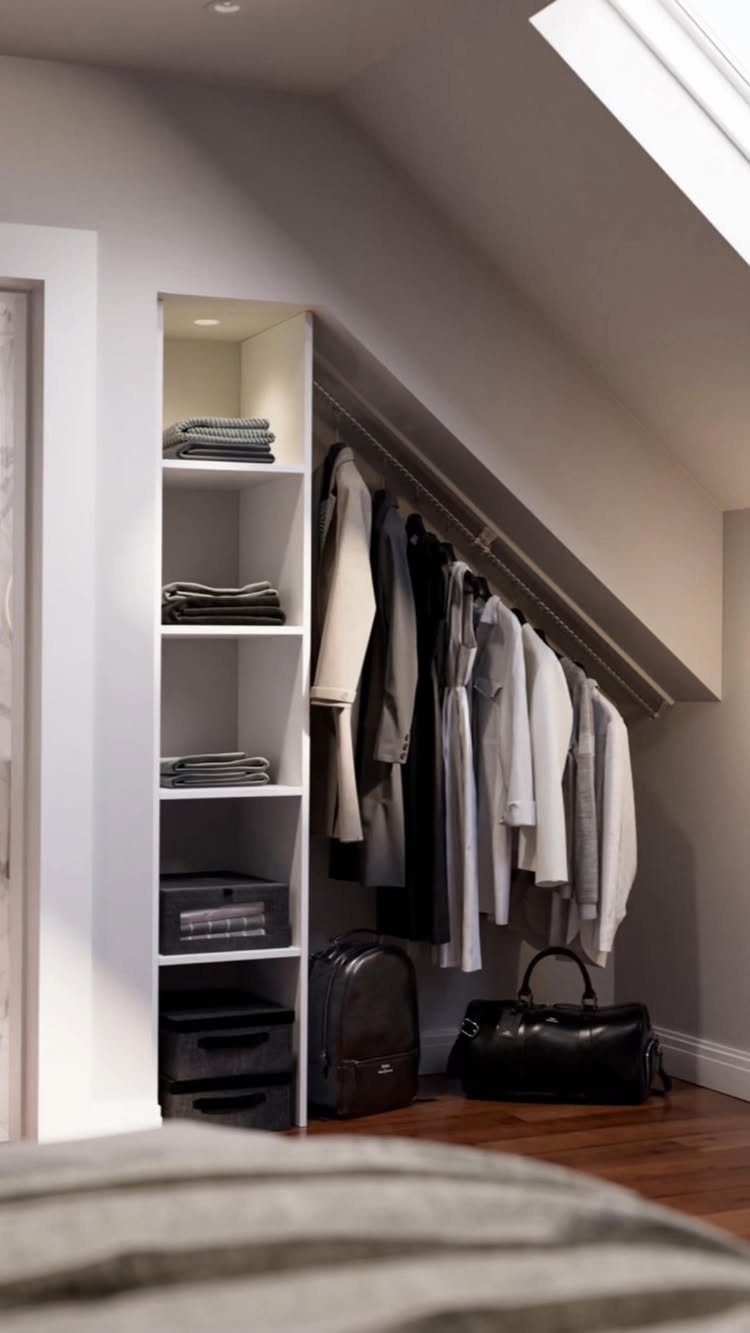 Clothing rail and white shelving unit installed under a slanted attic ceiling.