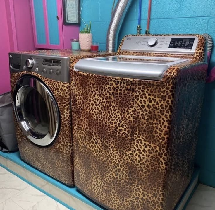 Leopard print washer and dryer in a bright blue and pink laundry room