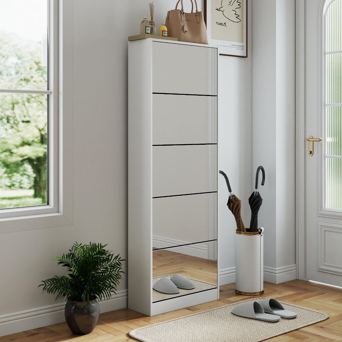 Slim white mirrored shoe cabinet in a bright entryway with an umbrella stand.