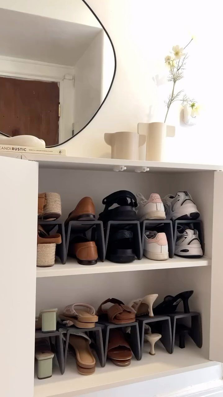White shelving unit with grey shoe slots organizing various sandals and sneakers.