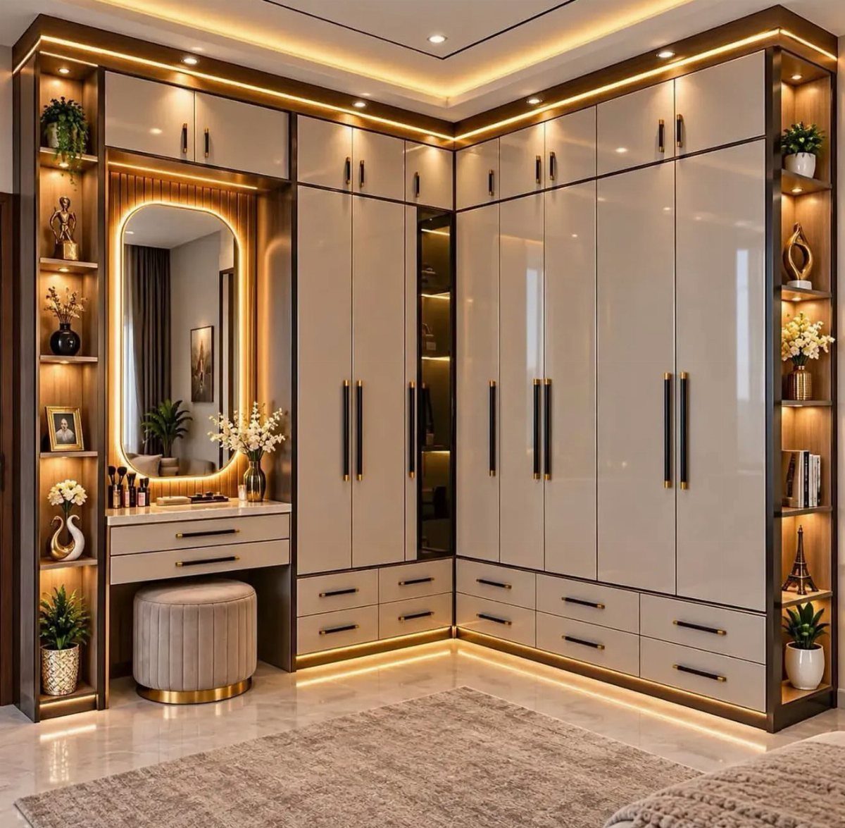 L-shaped walk-in closet with beige cabinets, integrated lighting, and a vanity mirror.