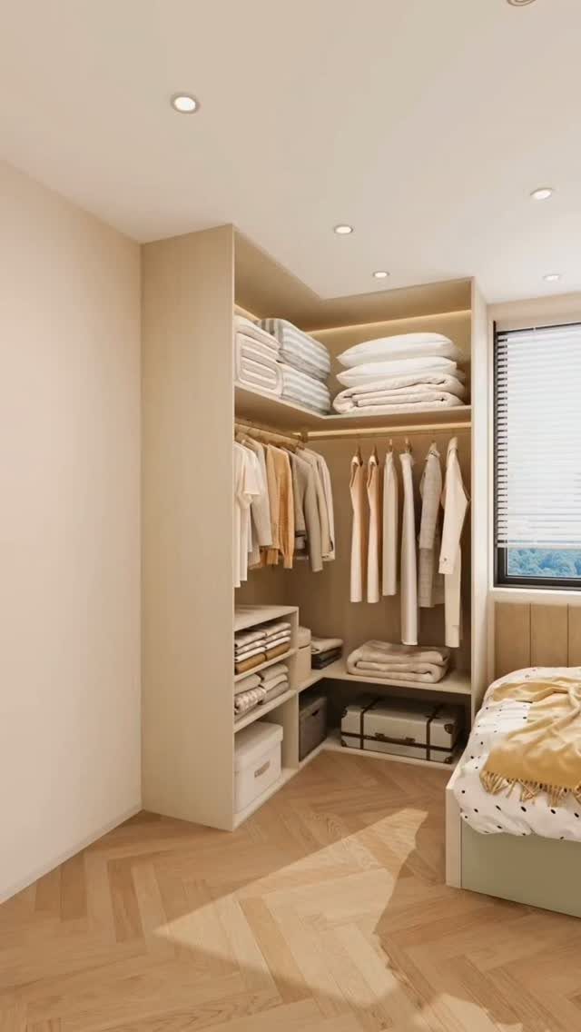 L-shaped walk-in closet with beige clothing, open shelves, and herringbone wood flooring.