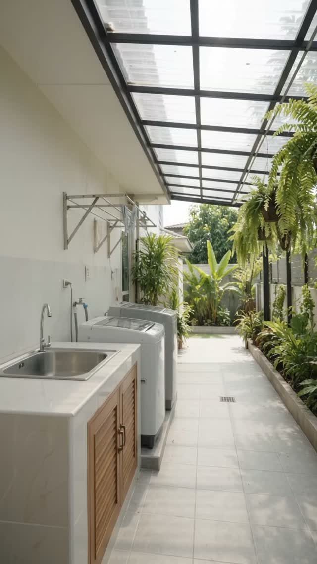 Outdoor laundry area with white top-loading washing machines and a sink counter.
