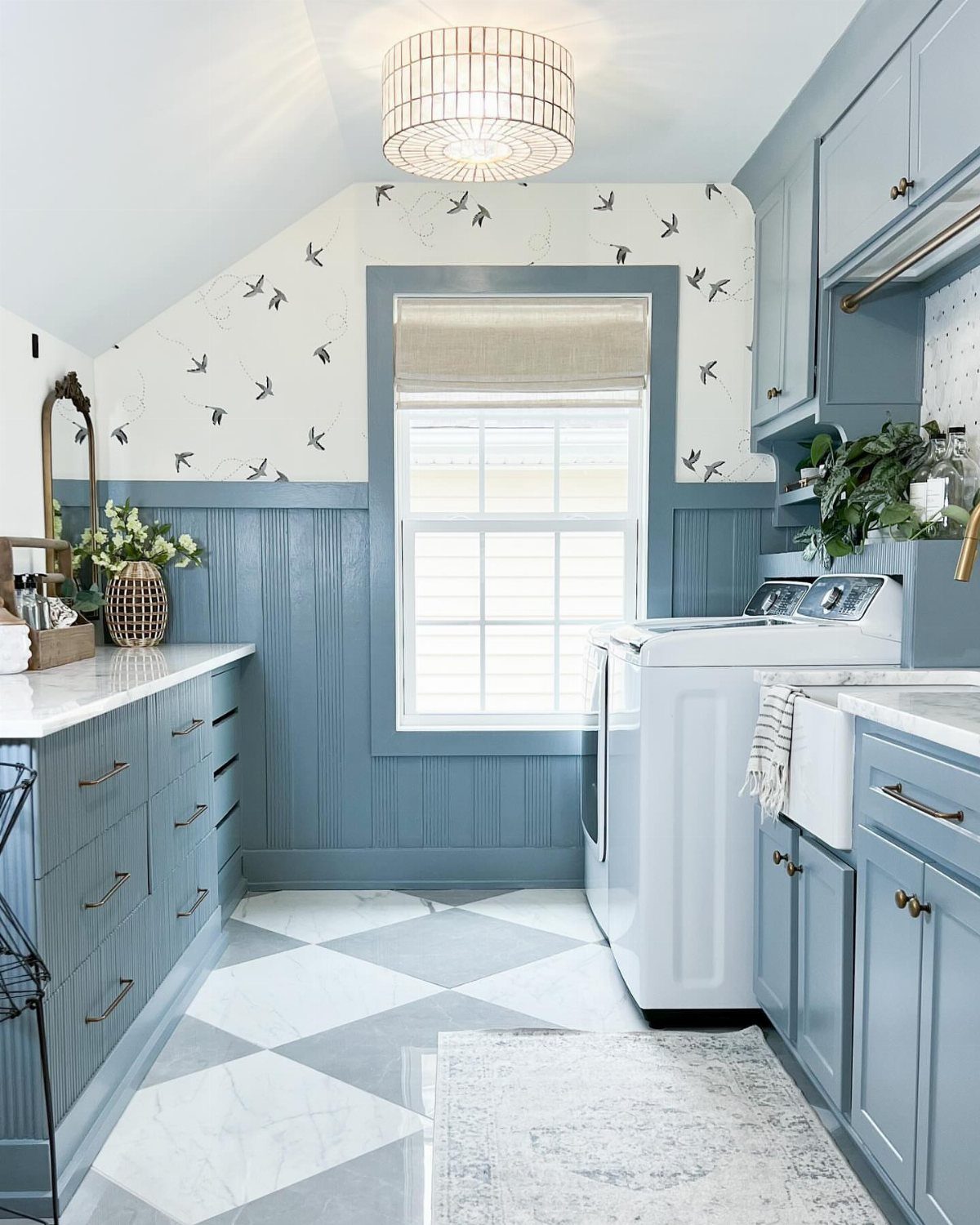 Drum-shaped ceiling light fixture in a blue and white laundry room