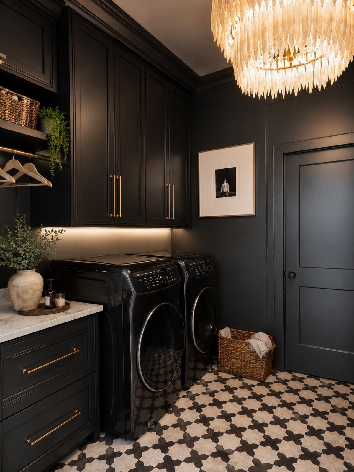 Dark charcoal gray laundry room with black appliances and patterned tile flooring
