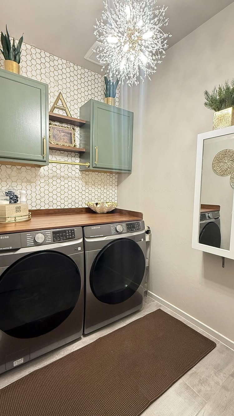 Laundry room with green cabinets and a large starburst chandelier providing ambient lighting.