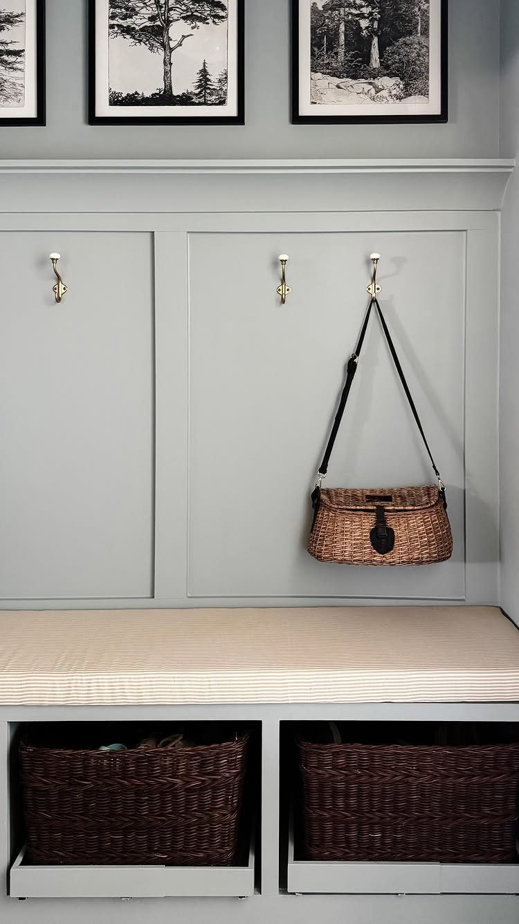 Woven storage baskets tucked into cubbies beneath a cushioned mudroom bench.