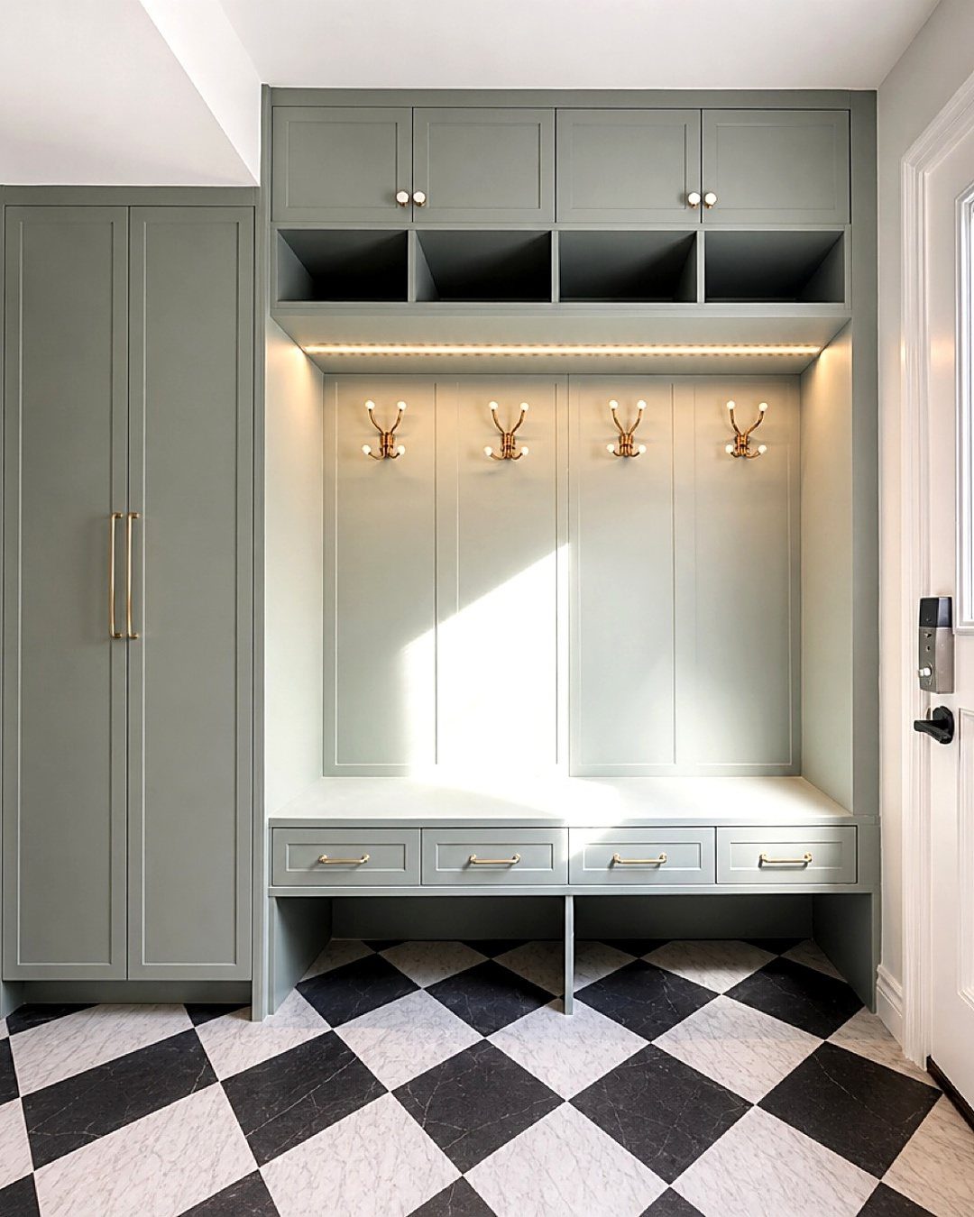 Grey built-in mudroom with recessed lighting, gold hooks, and checkered tile flooring.