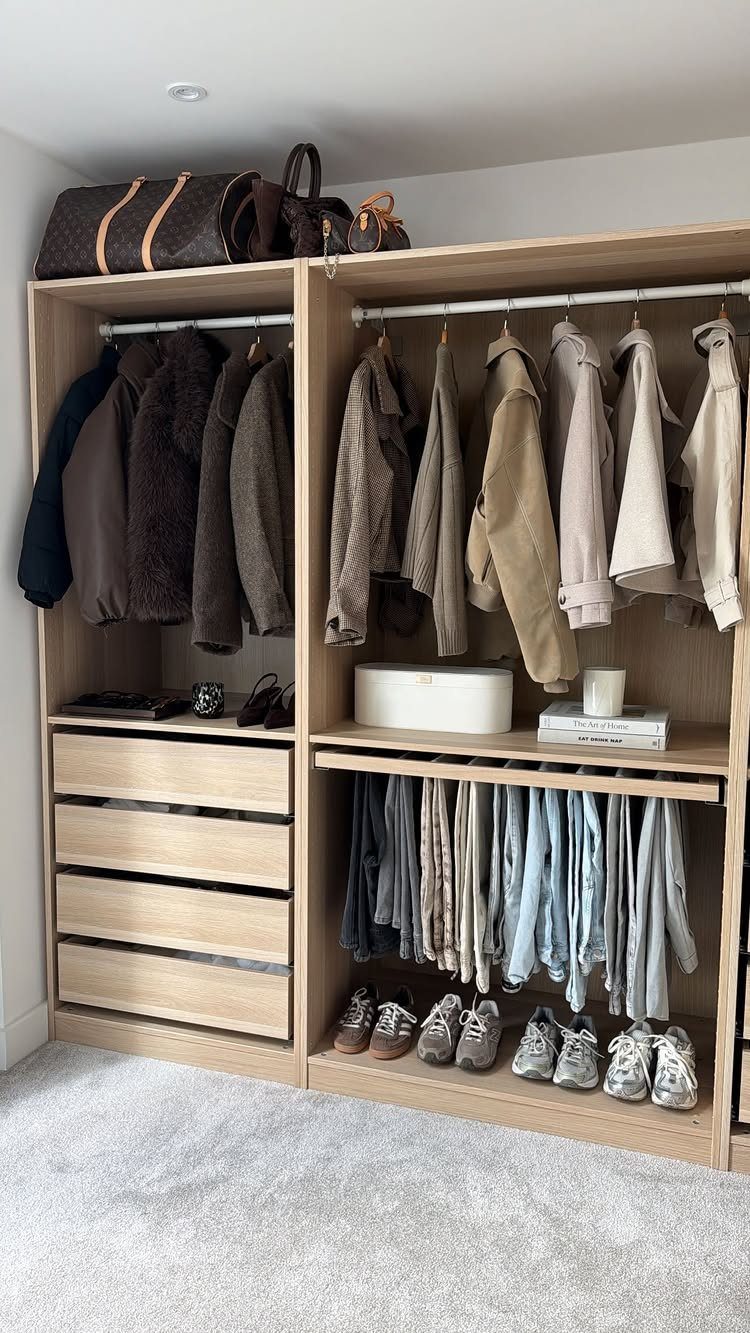Light wood closet system with hanging clothes, drawers, and shoes on bottom shelf
