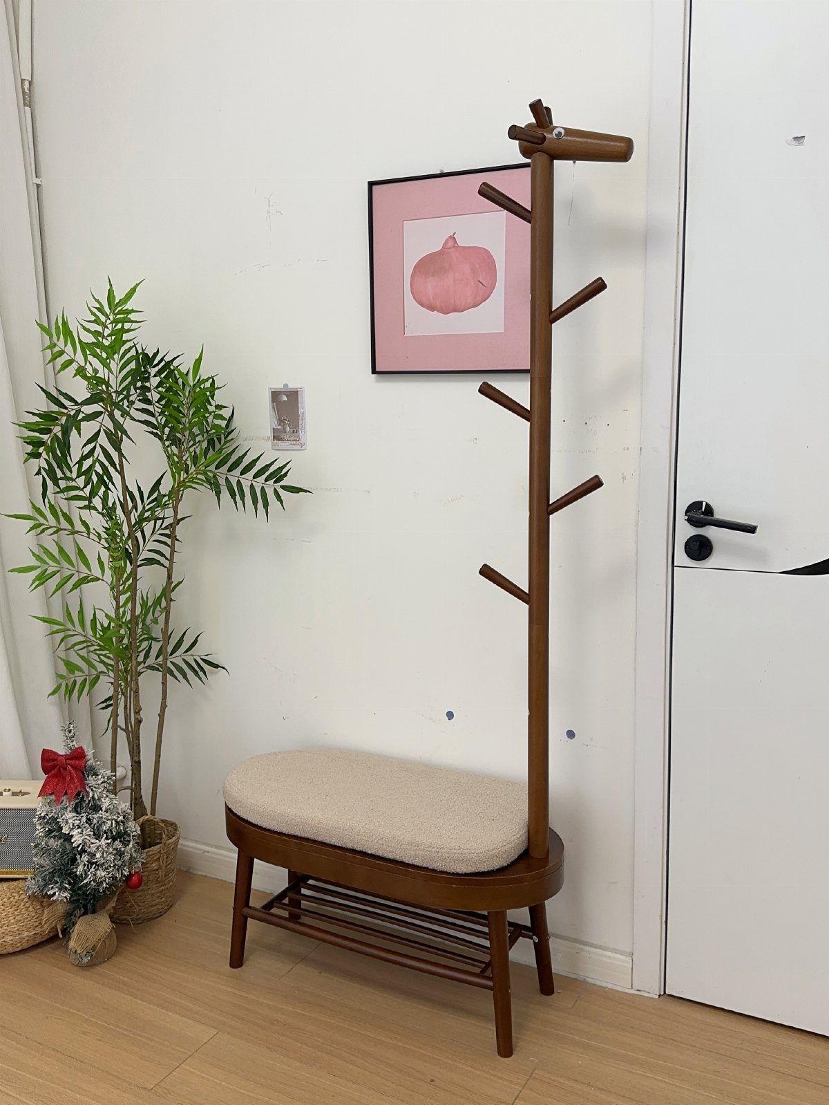 Wooden hall tree with a cushioned seat and slatted shoe storage rack