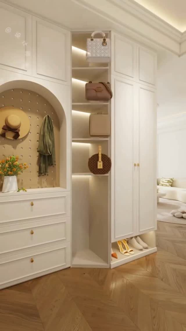 White built-in entryway storage unit with handbag shelves and bottom shoe compartment.
