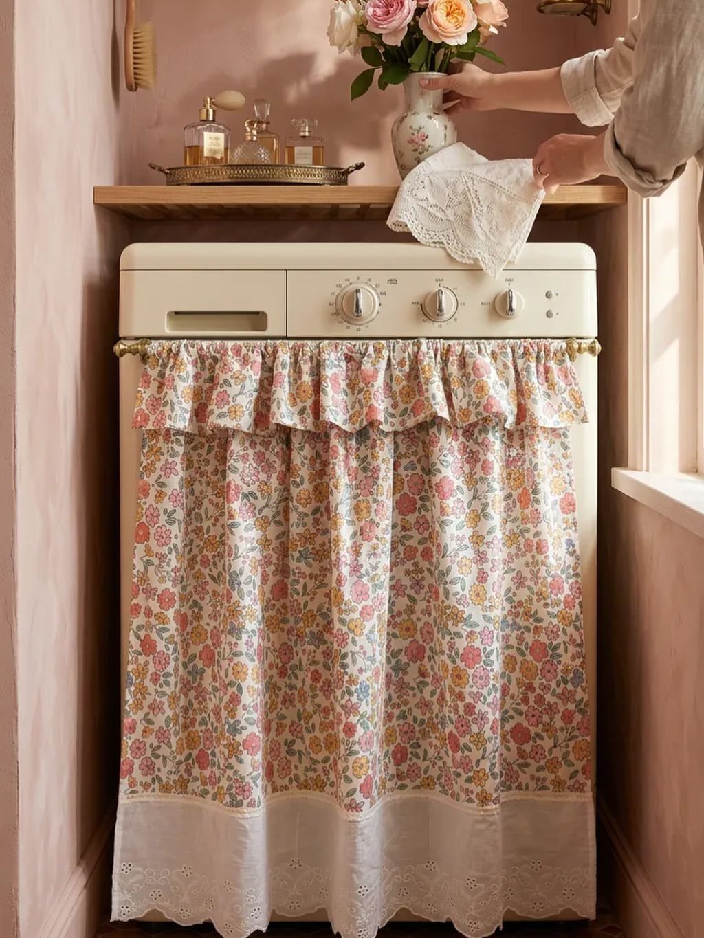 Floral curtain with lace trim concealing the bottom of a cream washing machine.