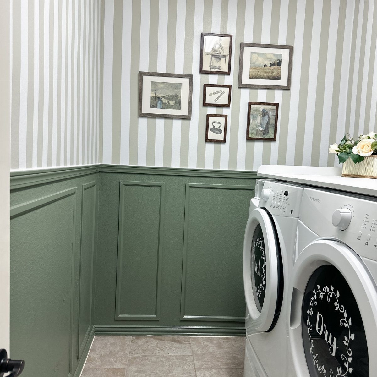 Striped wallpaper and green wainscoting in a small laundry room with white appliances.