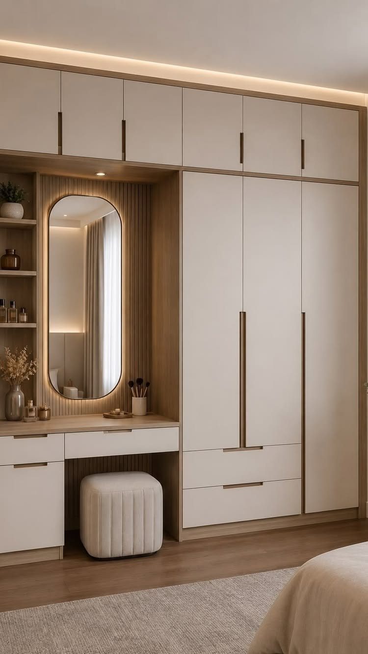 Built-in white wardrobe with integrated ceiling lighting and a backlit vanity mirror.