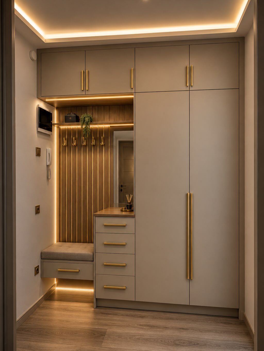 Modern mudroom with beige cabinets, wooden slats, and integrated warm LED strip lighting.