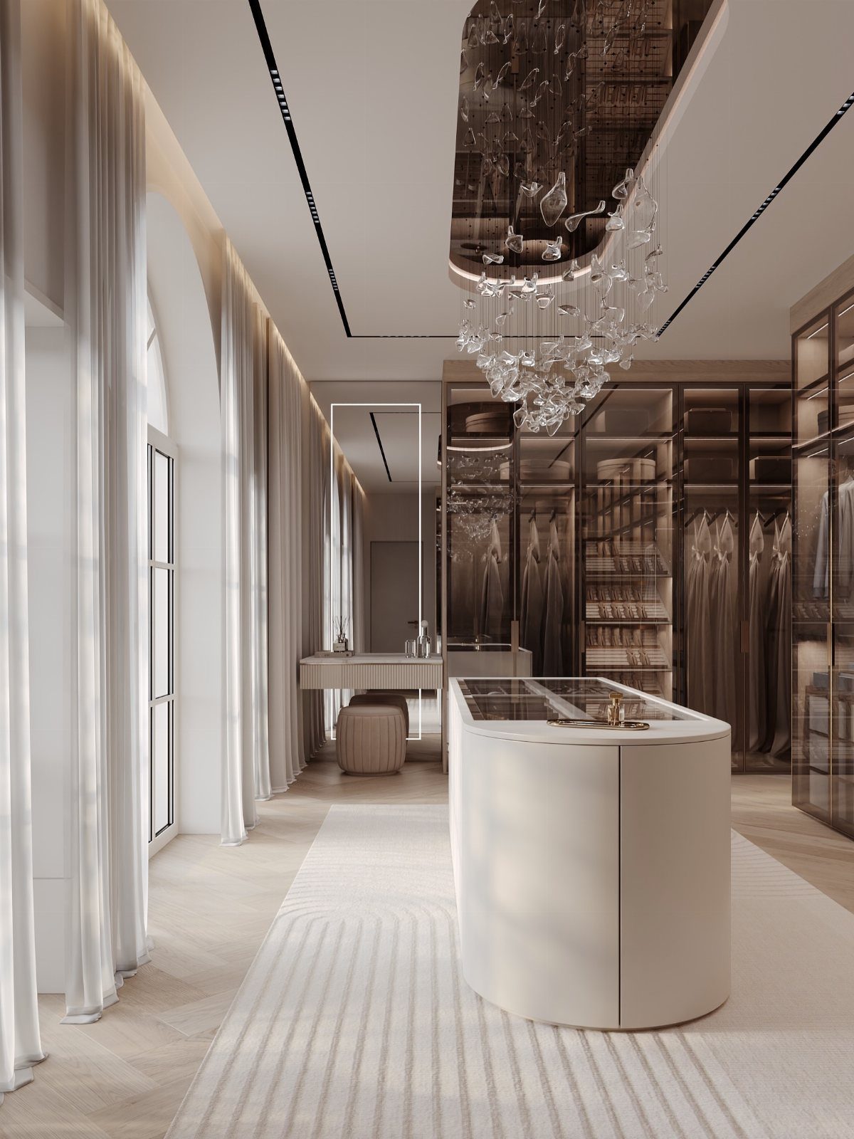 Luxurious walk-in closet with a central white island and a crystal chandelier.