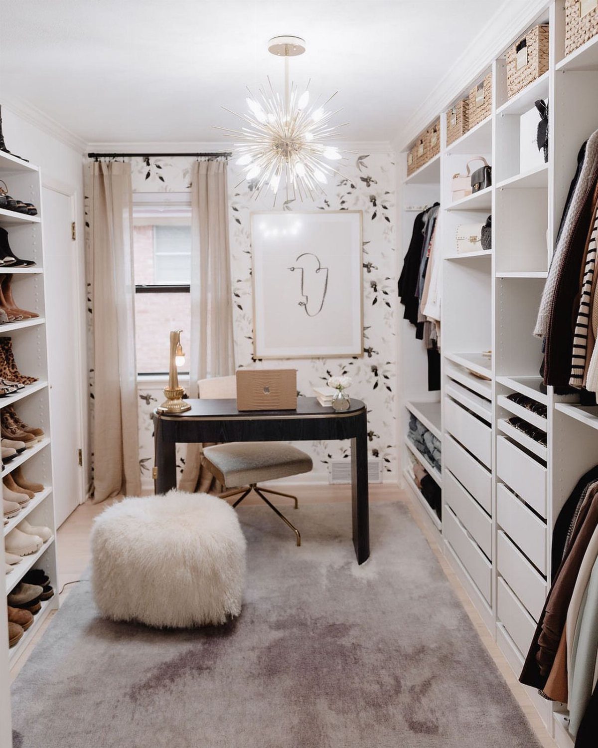 Walk-in closet with white shelving and a black desk for a home office.