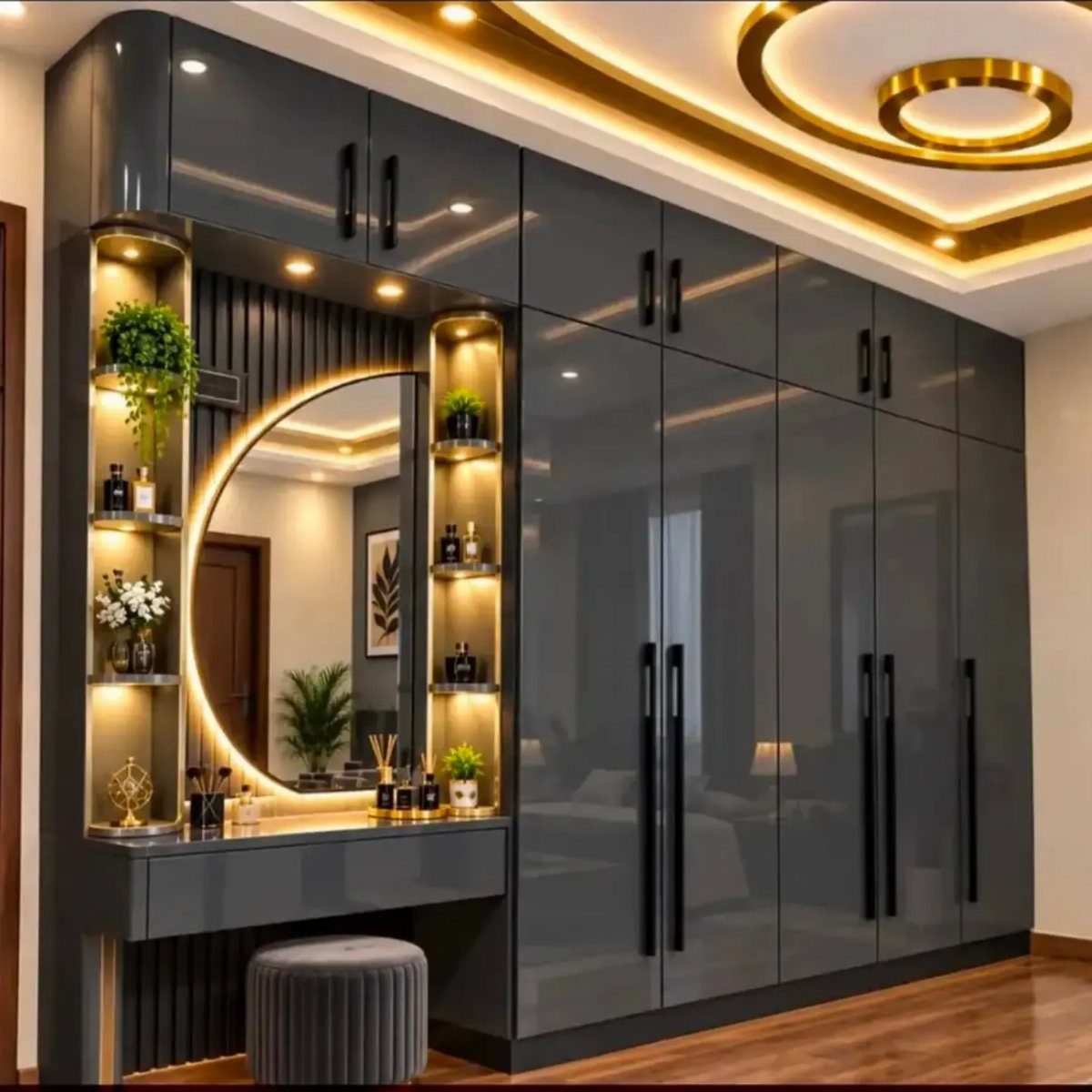 Grey glossy wardrobe with an integrated vanity table, round mirror, and velvet stool.