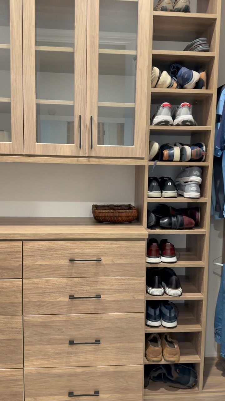 Light wood closet shelving unit with a vertical column of organized shoes.