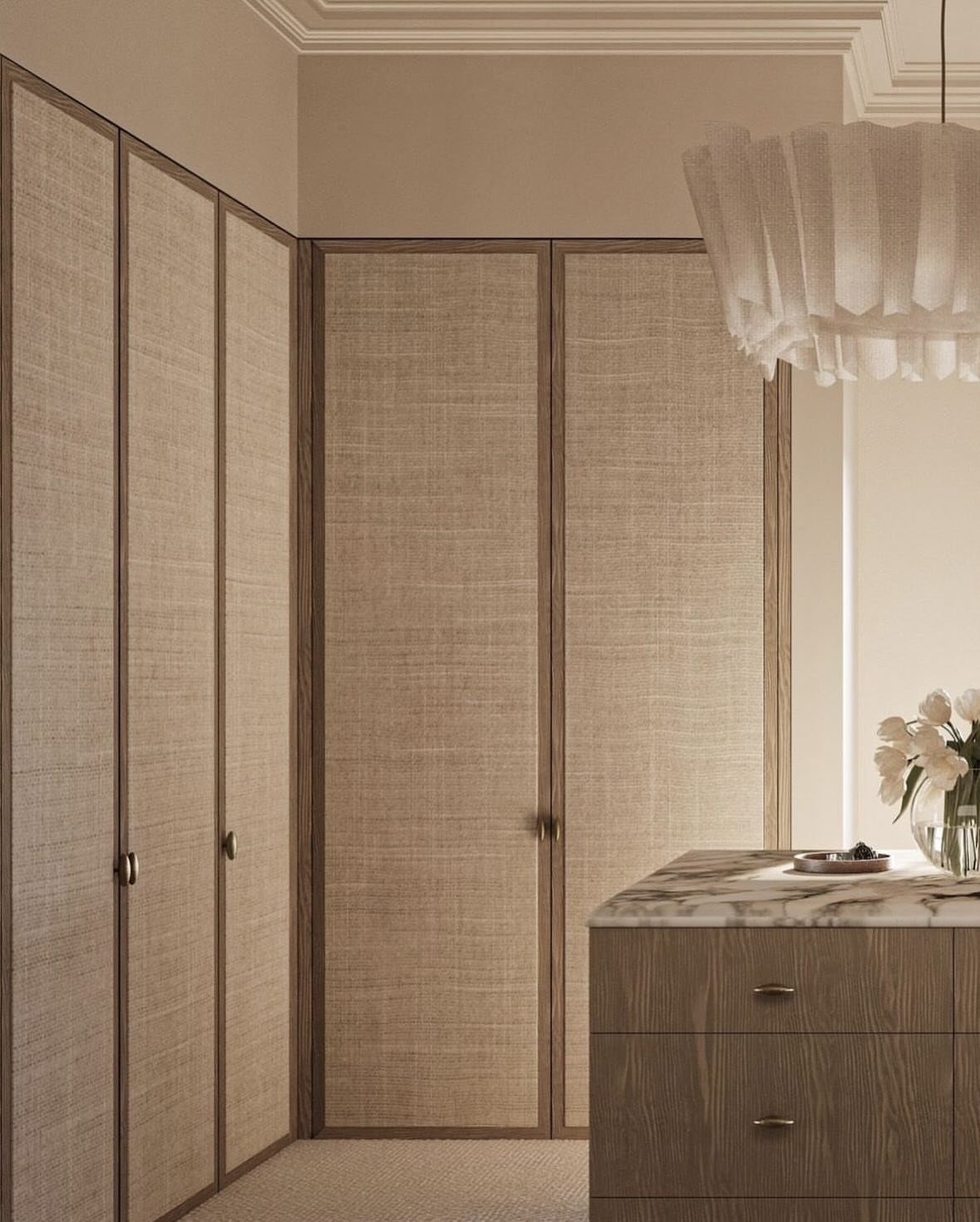 Beige linen-textured closet doors with dark wood frames in a modern room.