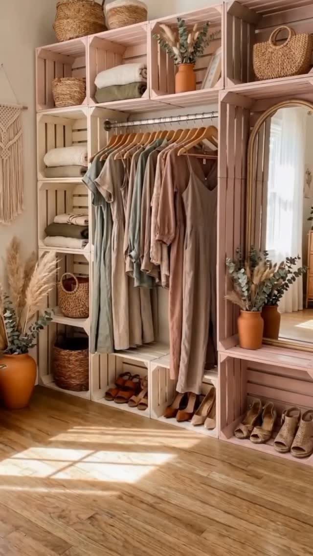 Pink wooden crate closet system with hanging clothes, baskets, and shoe storage.